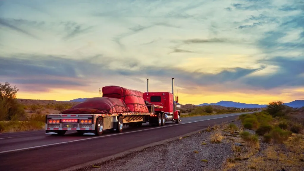 Loaded Red Arched Flatbed Trailers on a Highway